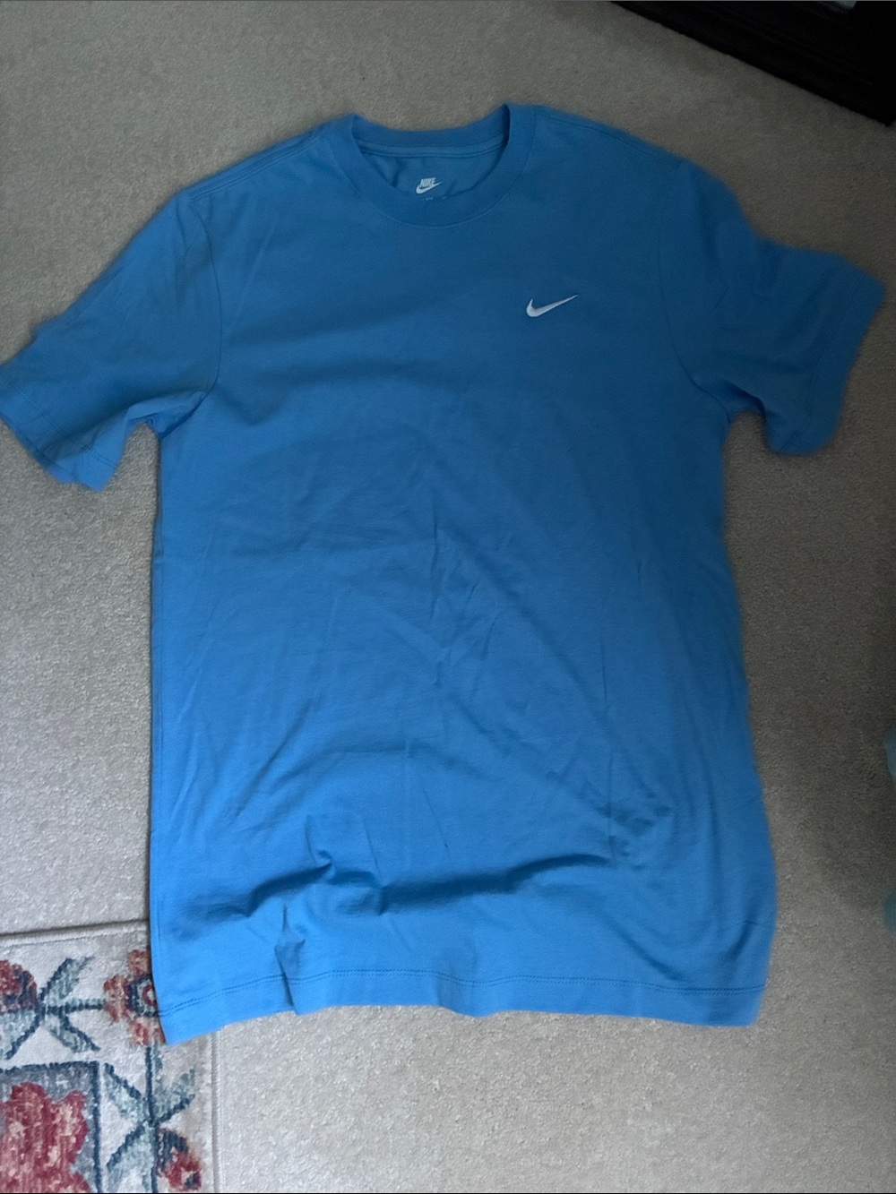 The Nike tee Nike Men’s Light Blue Crew Neck T-Shirt with White Swoosh